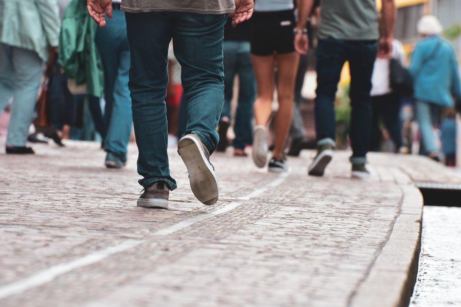 People Walking on Gray Concrete Pavement